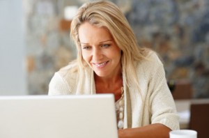 Mature lady studying at computer